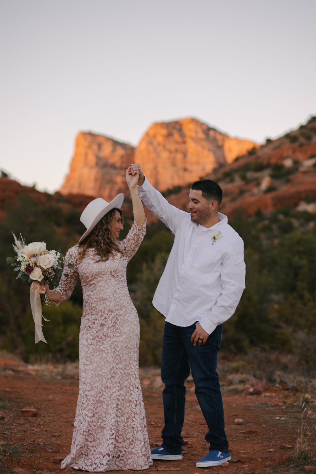 Newlyweds Dancing in Rocky Landscape